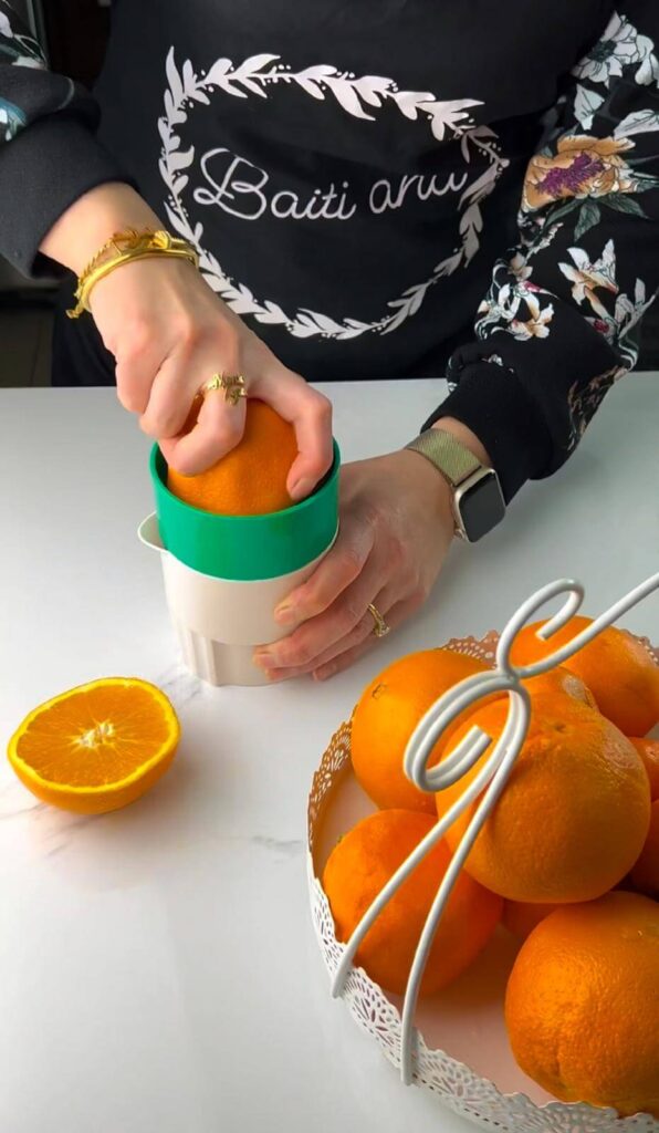 fresh orange being squeezed for juice essential .