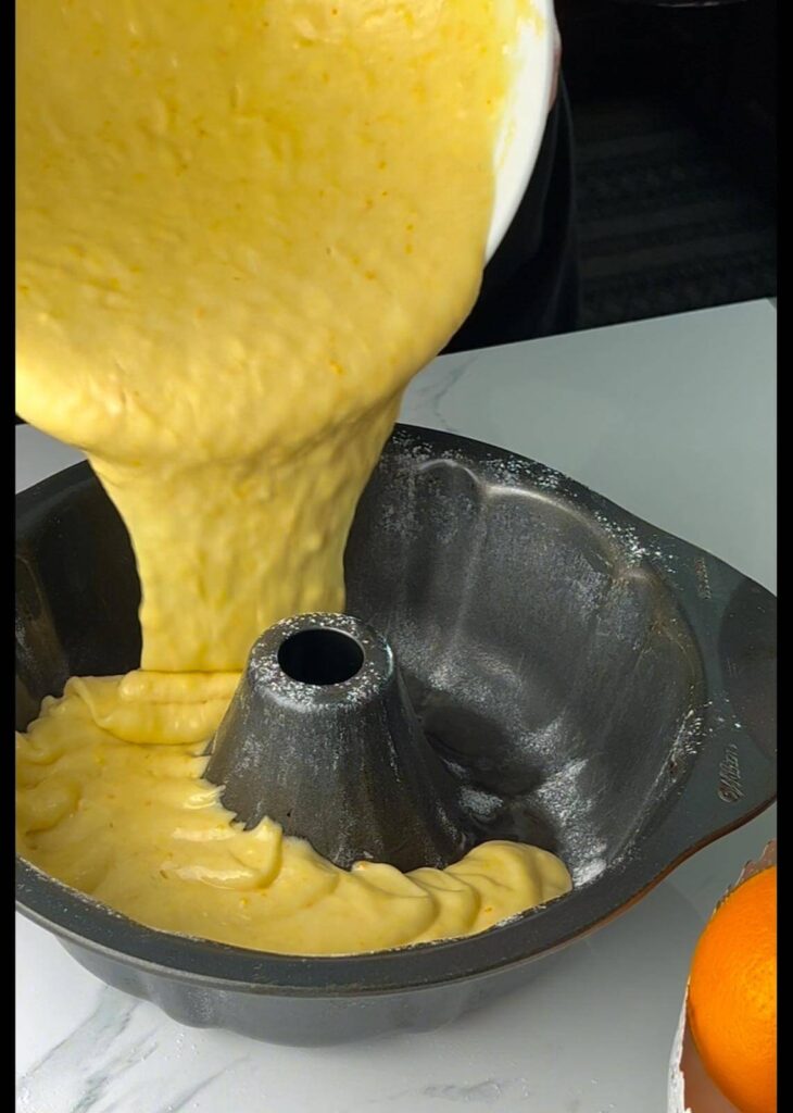 pour the orange cake batter in  the tray 