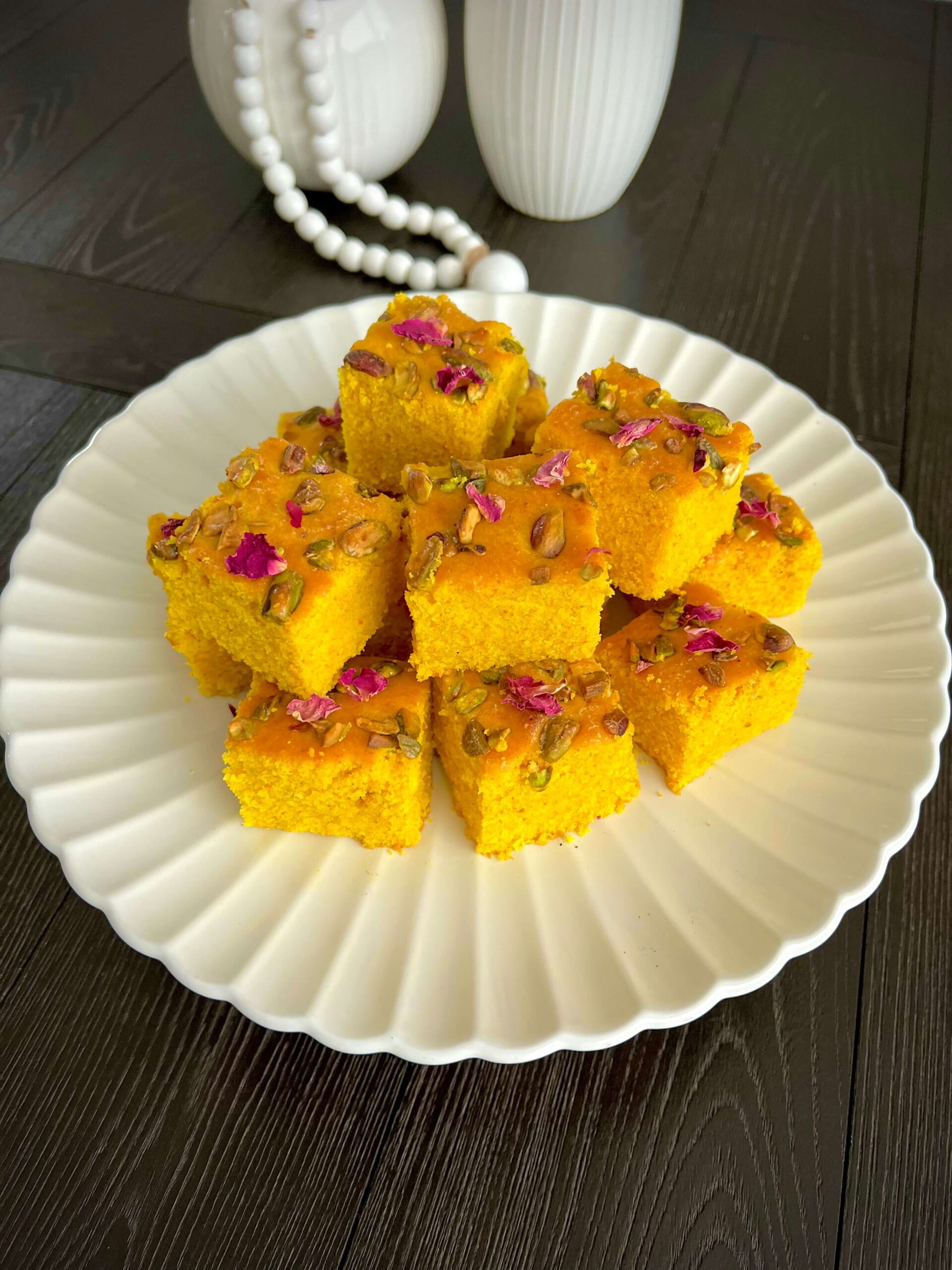 Golden Sfouf turmeric cake with pistachios and pine nuts on top.