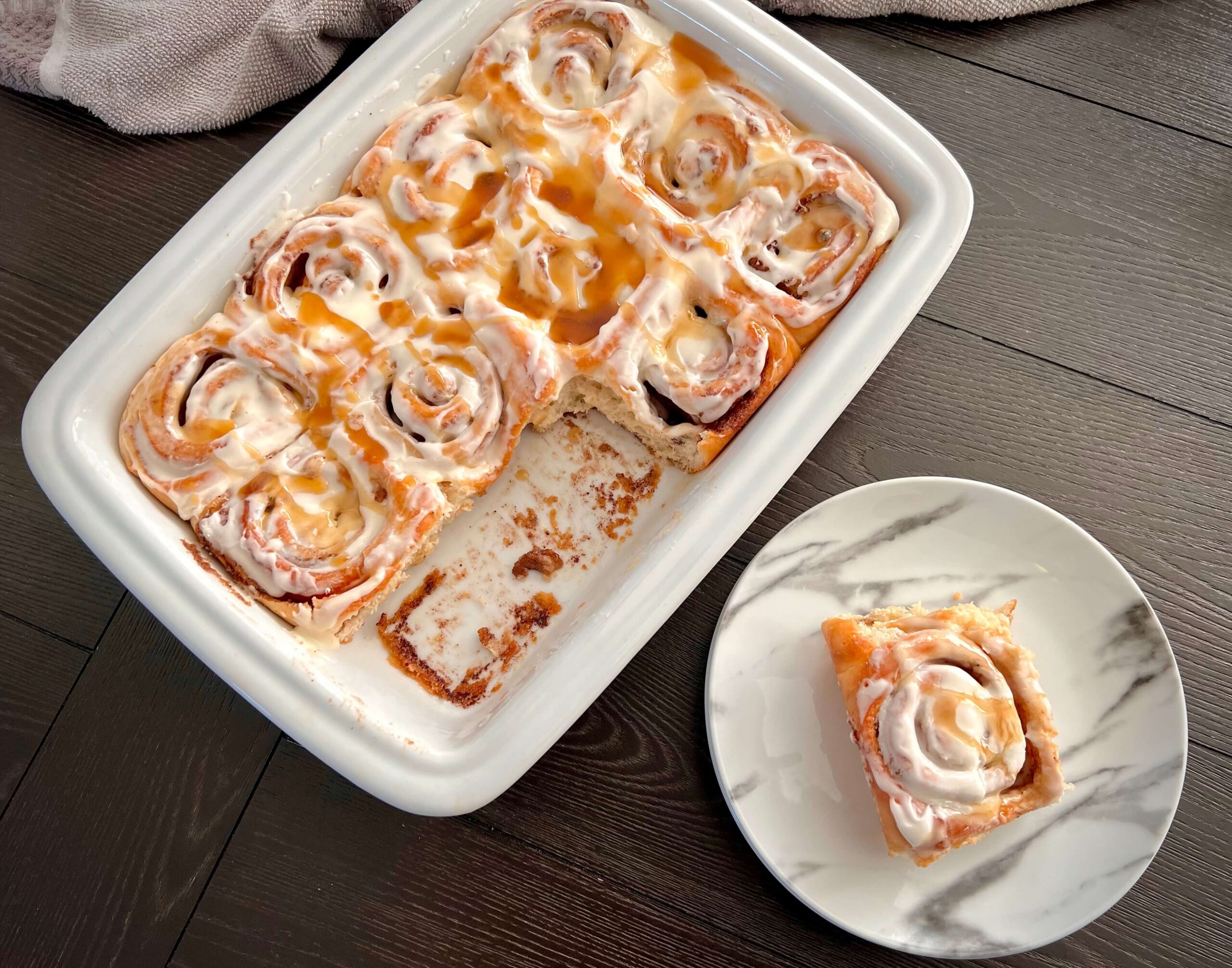 Freshly baked cinnamon rolls topped with icing.