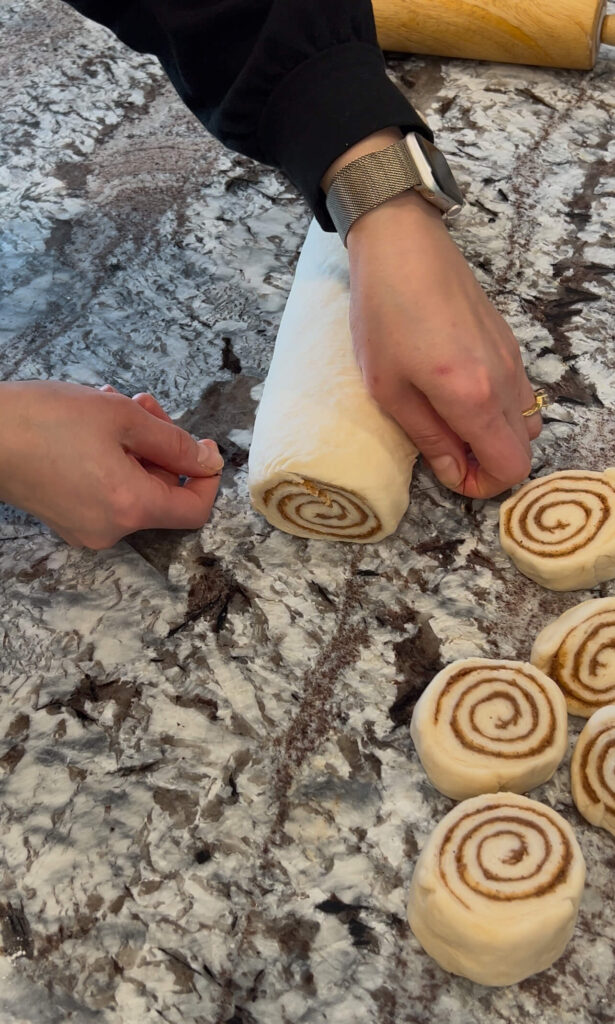 "Cutting  rolling the dough and filling."