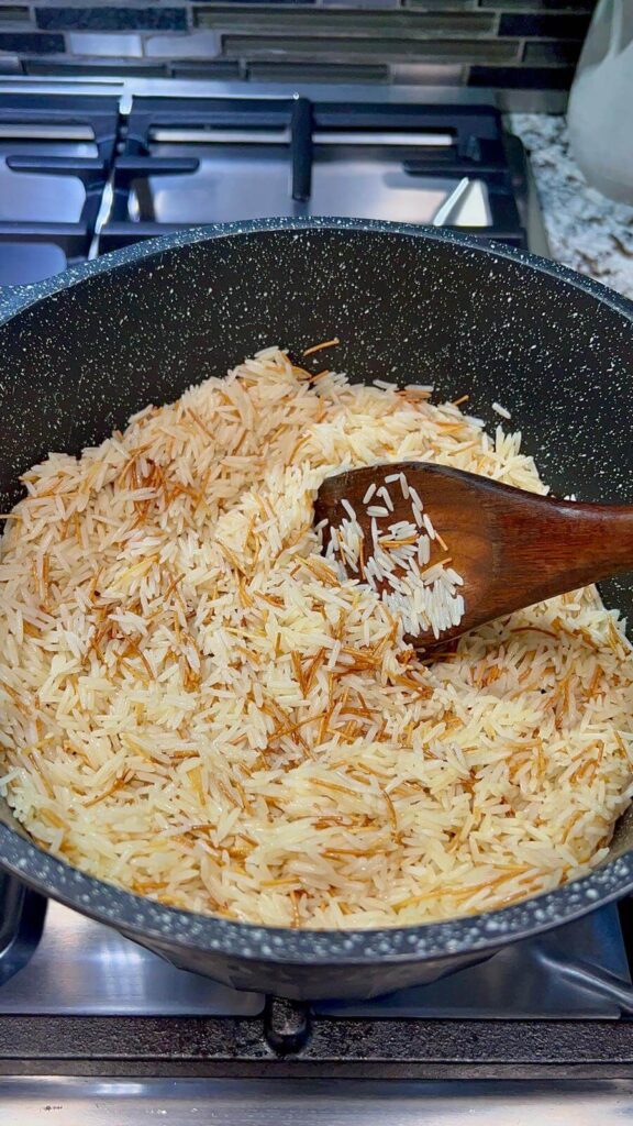 stirring the rice  gently to ensure each grain is coated with the oil