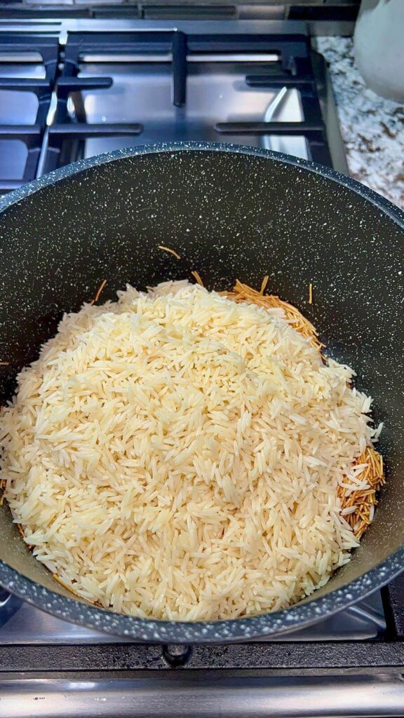 adding the rinsed rice and salt to the pot