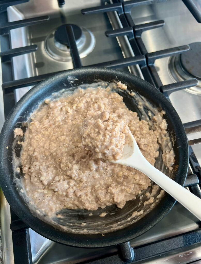 Finishing the Peanut butter banana oatmeal  with adding milk and mixing 