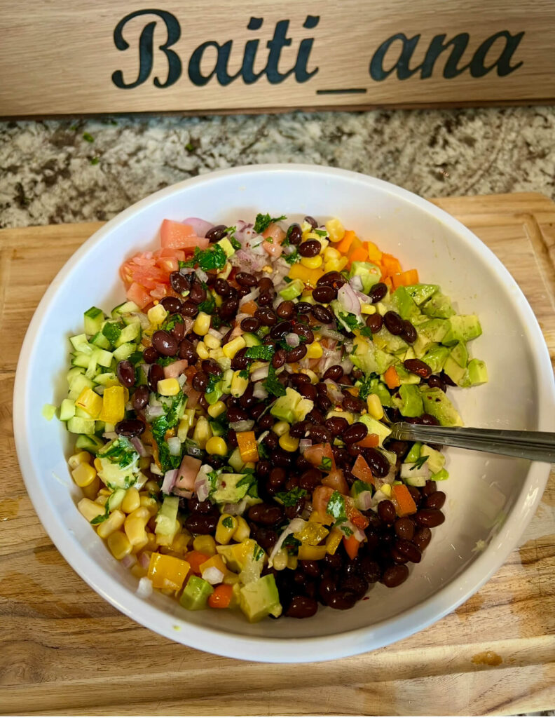 Mixing the ingredients for the Black bean salsa  with the dressing 