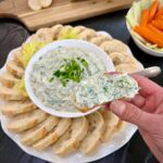 Serving Spinach dip with bread
