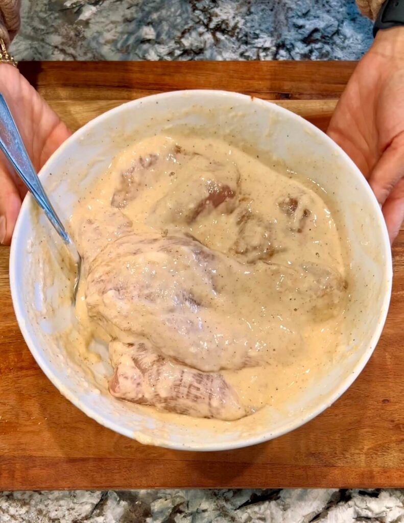 Mixing the chicken with spices and making the batter 