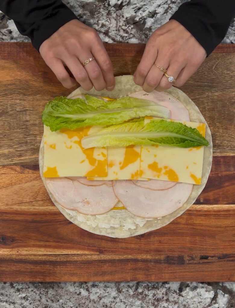 Deli meat slices with mayo mustard lettuce and cheese pinwheels 