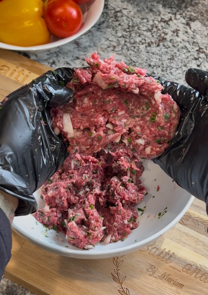 Preparing the meat for Baked kafta (Kafta bilSaniyeh)