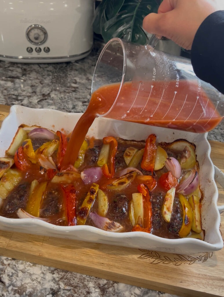 Adding the sauce for Baked kafta (Kafta bilSaniyeh)
