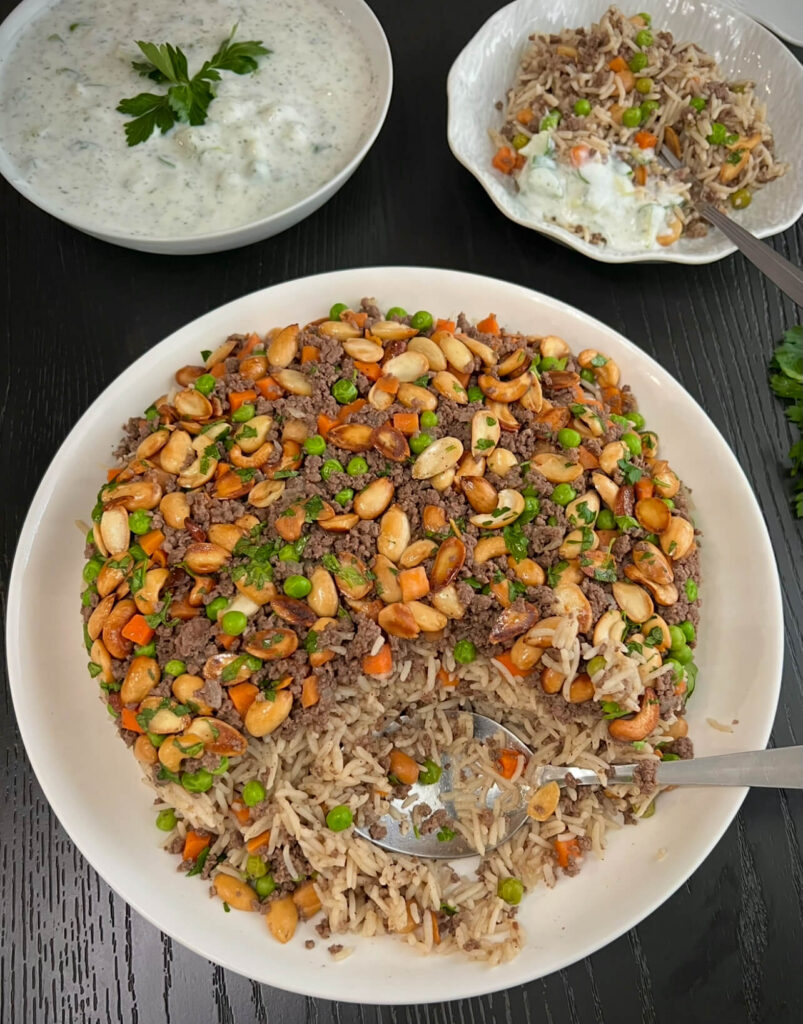 Serving Ouzi rice with cucumber yogurt sauce 