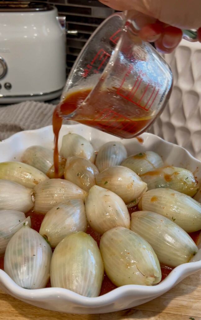 Adding the liquid sauce on top the stuffed onion 