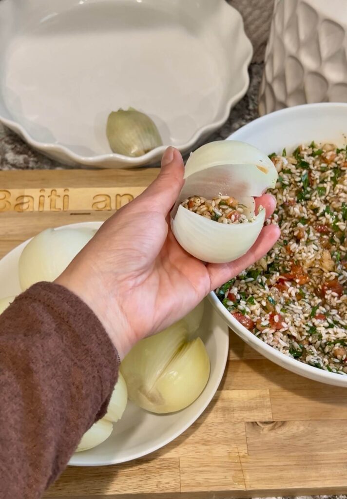 Stuffing the onion with rice filling 