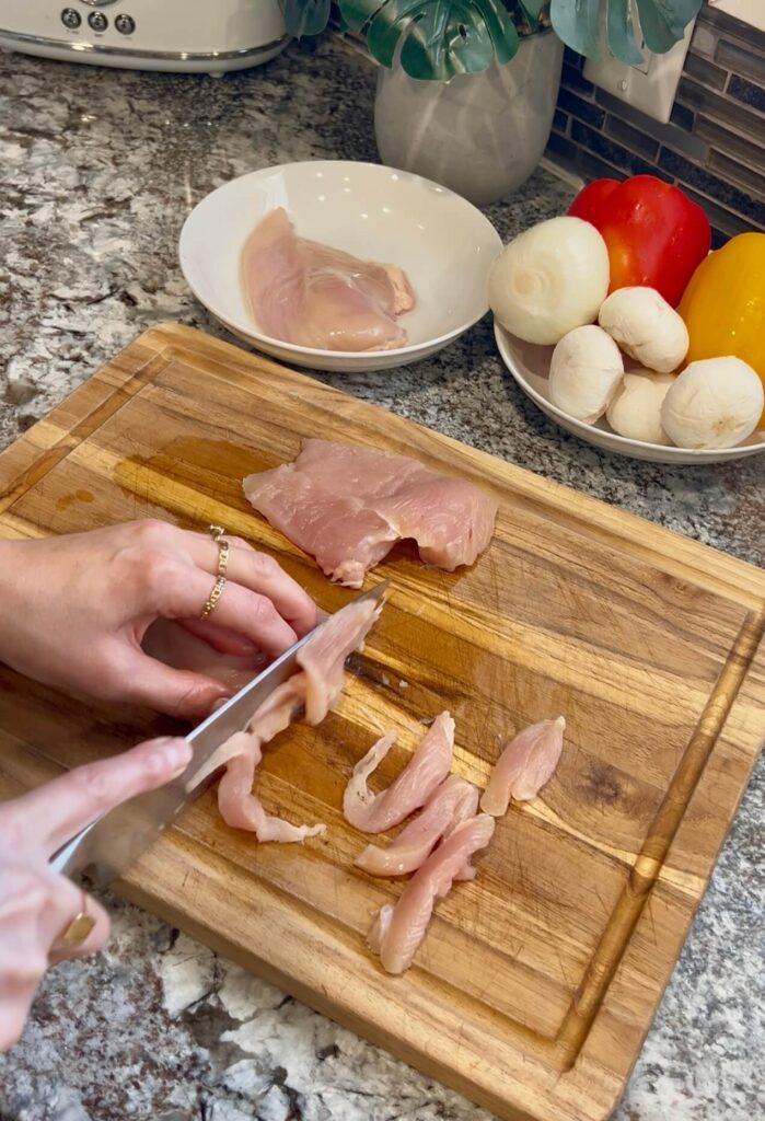 Cutting chicken into thin strips for the Lebanese chicken fajita 