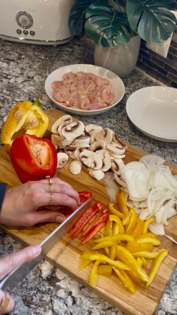 Cutting onion, sweet bell pepper and mushrooms into thin slices 
