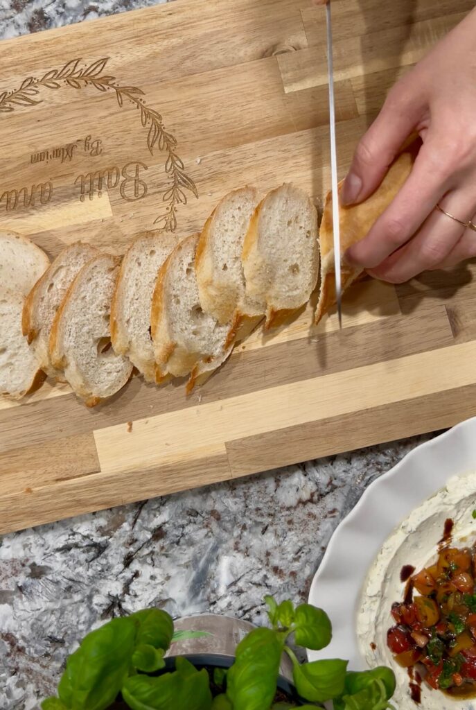 Cutting the bread into thin slices for the Bruschetta Cheese Dip