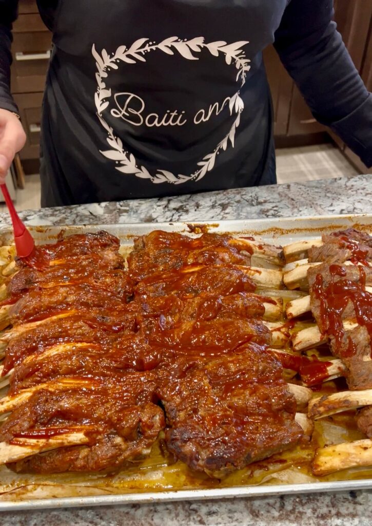 Brushing Beef back ribs with bbq sauce 