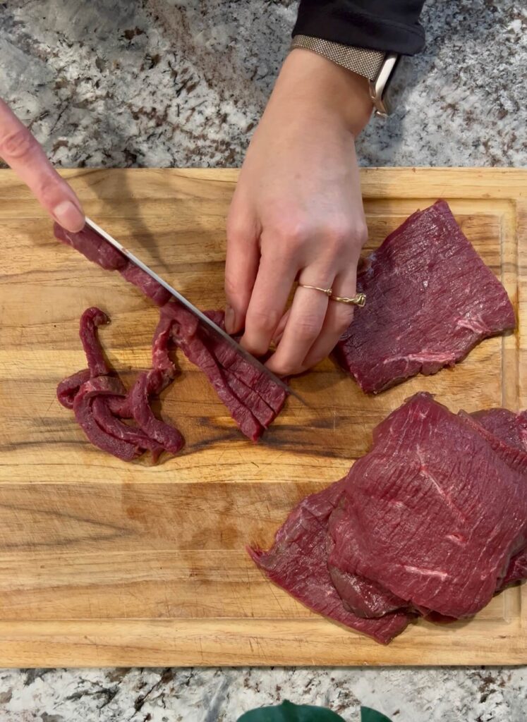 Cutting the meat into small thin strips for the ginger beef