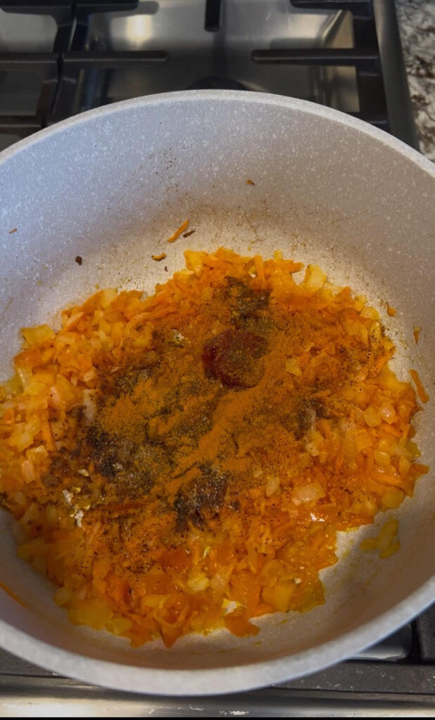 Cooking onion, garlic, tomatoe, shredded carrots with spices