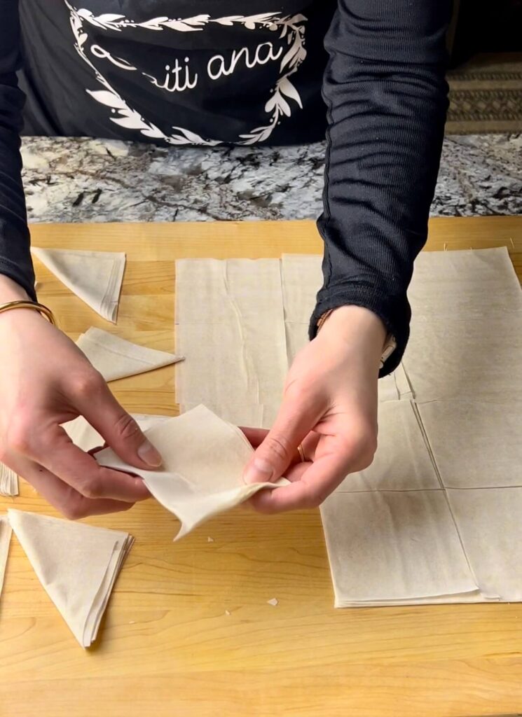 Cut the phyllo dough into small squares to make Warbaat bi ashta crspy phyllo